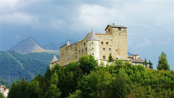 Castle on a hill with mountains and trees 4K