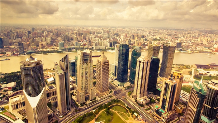 Aerial view of a sprawling metropolis with skyscrapers and a river