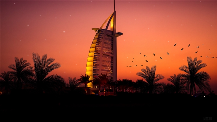 Burj Al Arab at sunset with palm trees