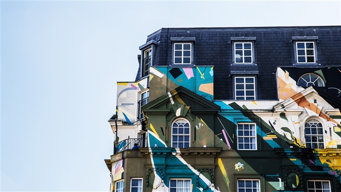 Colorful building facade with windows against a clear sky