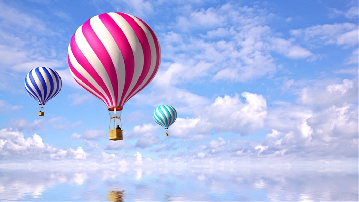 Hot air balloons flying over the sea with clouds