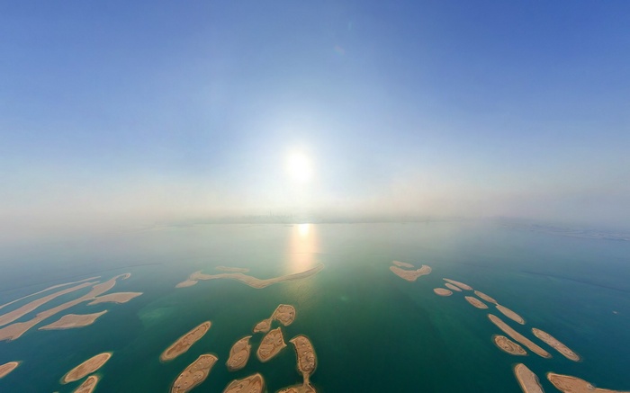 Artificial islands in the sea at sunset