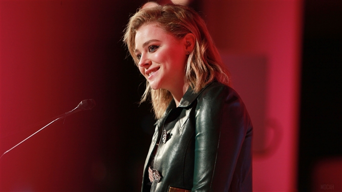 Chloe Grace Moretz speaking at podium 4K
