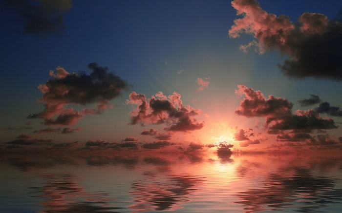 Sunset over the ocean with clouds and reflections