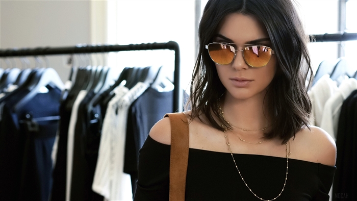 Kendall Jenner wearing sunglasses and necklaces