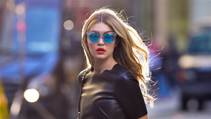 Gigi Hadid wearing sunglasses and a black dress