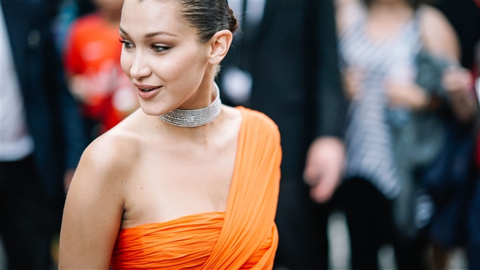Bella Hadid in orange dress with diamond choker