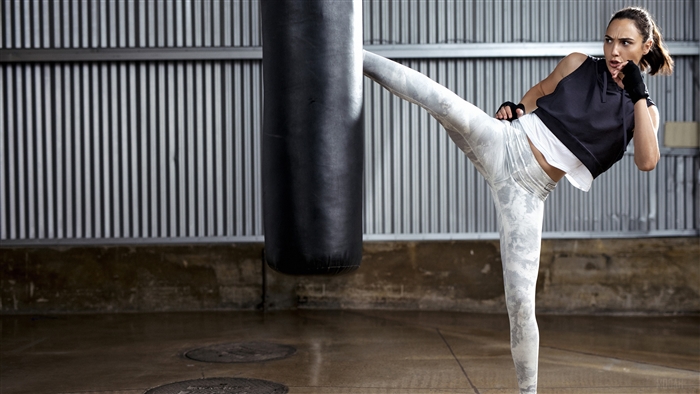 Gal Gadot practicing martial arts with a punching bag