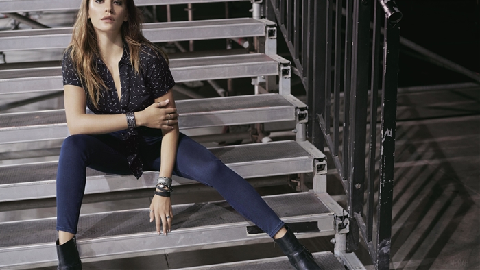 Serenay Sarikaya sitting on bleachers
