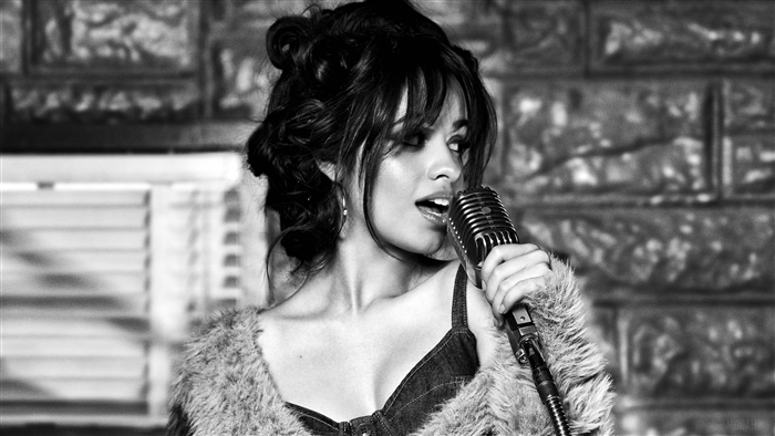 Camila Cabello singing into a vintage microphone