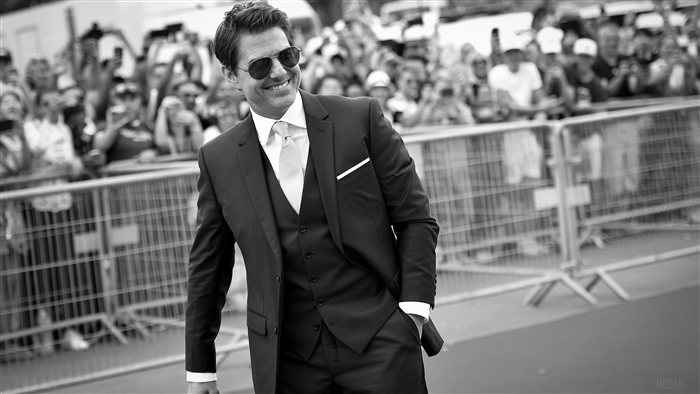 Tom Cruise in a suit on a red carpet