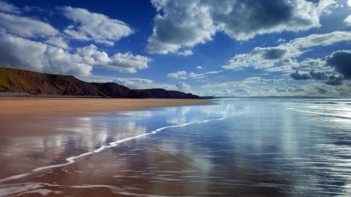 Beach with cliffs and reflections