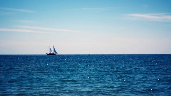 Sailboat on the blue ocean under a clear sky