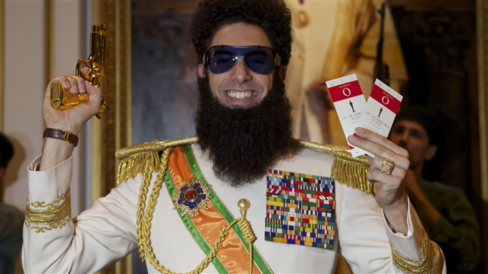Admiral General Aladeen from The Dictator holding Oscar tickets and a gun
