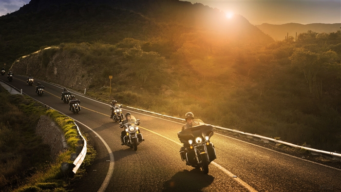Harley Davidson Riders on a Mountain Road at Sunset