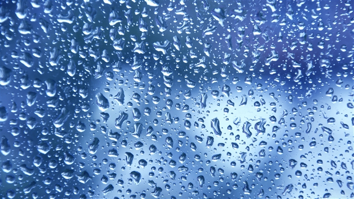 Water drops on blue glass 4K