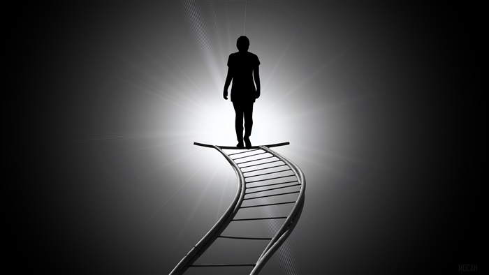 Silhouette walking up a glowing staircase