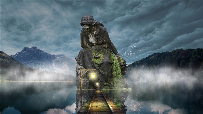 Stone sculpture on a lake with mountains and stormy sky
