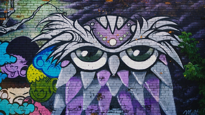 Graffiti owl and cartoon faces on brick wall 4K