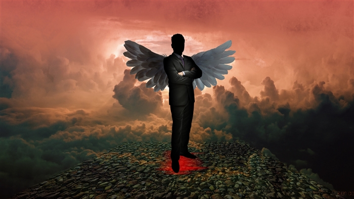 Silhouette angel with wings on rocky ground