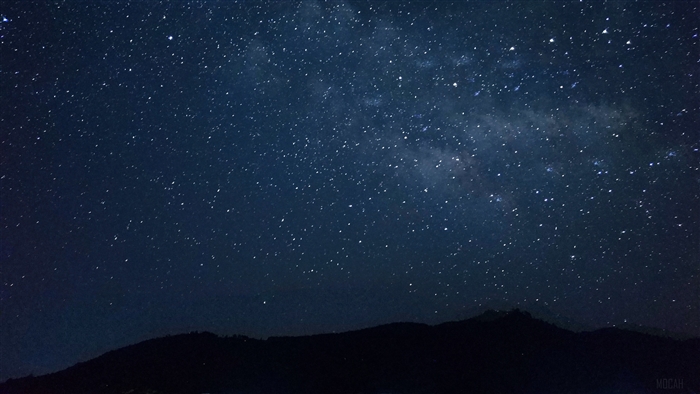Starry night sky over mountains 4K