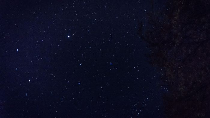 Starry night sky with dark silhouette