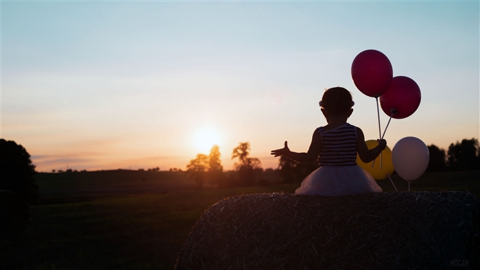Child with balloons at sunset 4K