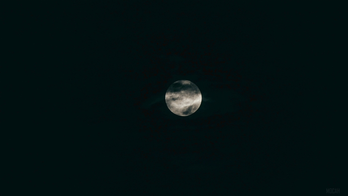 Full moon partially obscured by clouds 4K