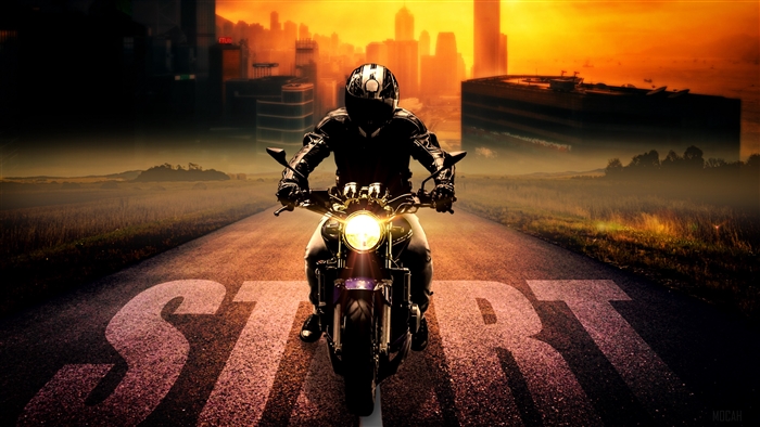Motorcyclist on a road with 'START' painted on it
