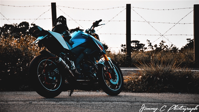 Yamaha motorcycle parked by a fence