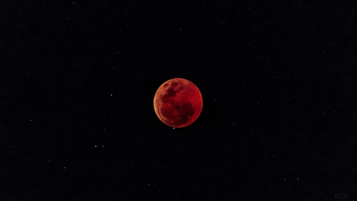 Red moon during a lunar eclipse in a starry sky