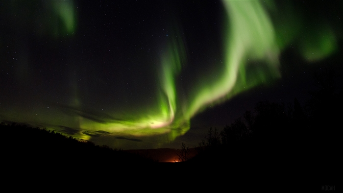 Aurora Borealis over a dark landscape