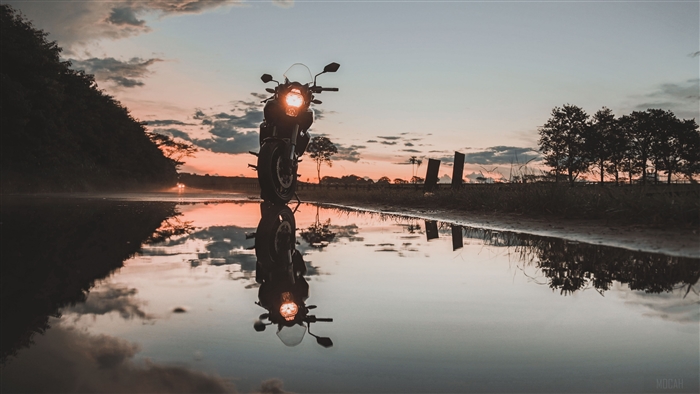 Motorcycle reflection in water at sunset 4K