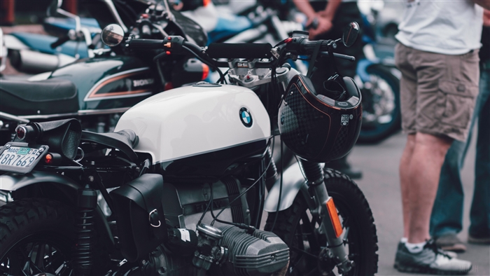 BMW motorcycle with helmet and people