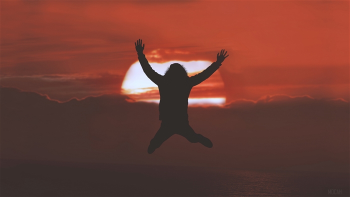 Silhouette jumping at sunset with horizon 4K