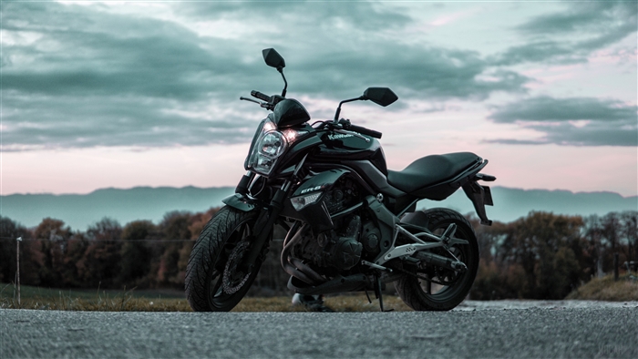 Black Kawasaki ER-6n motorcycle on a road