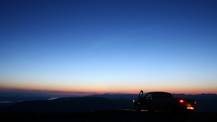 Pickup truck parked on a hill at dusk