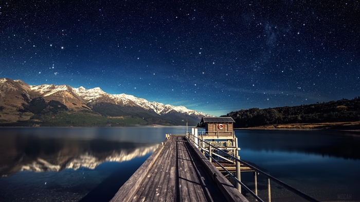 Wooden Pier and Mountains Under Starry Sky