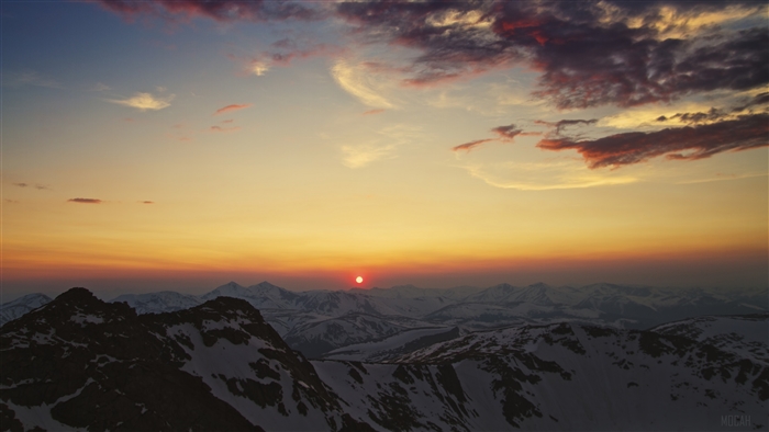 Sunset over snow-capped mountains