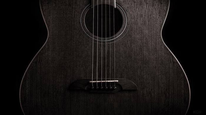 Close-up of a dark acoustic guitar
