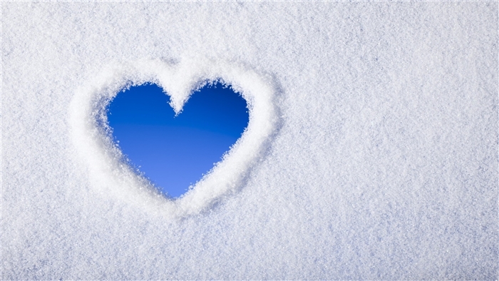 Heart shape in snow with blue sky