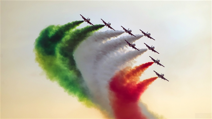 Frecce Tricolori jets flying in formation with colored smoke