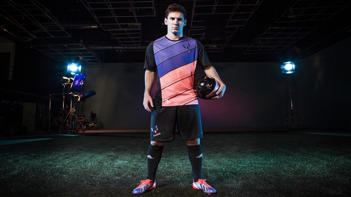Lionel Messi in Adidas uniform holding a soccer ball
