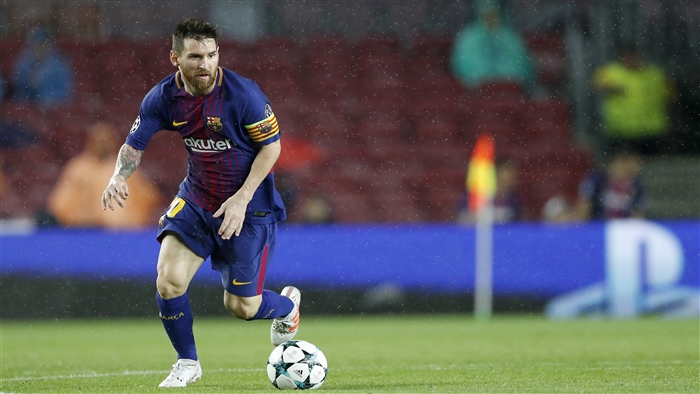 Lionel Messi from FC Barcelona playing soccer in the rain