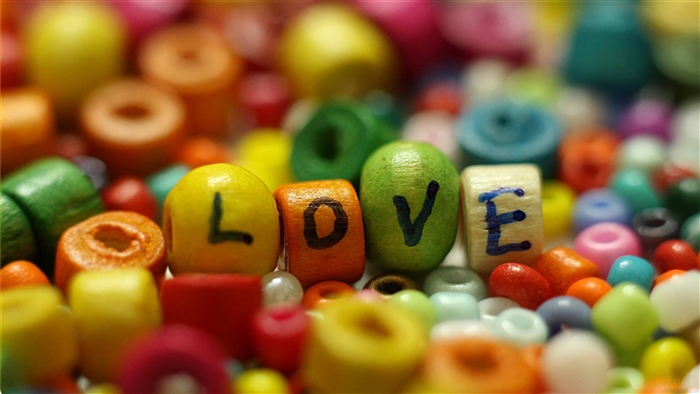 Love spelled with colorful beads 4K