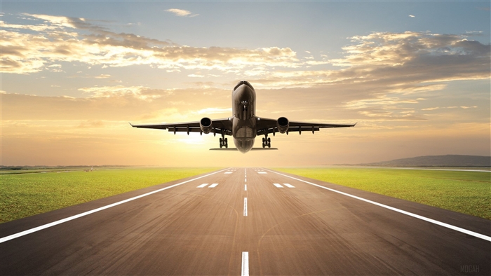 Airplane taking off on a runway at sunset 4K