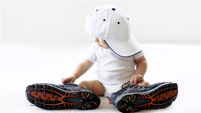 Baby in a white cap with shoes