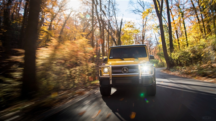 Yellow Mercedes AMG G 63 Colour Edition on a road