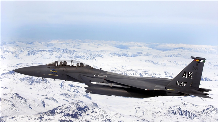 F-15E Strike Eagle over snowy mountains 4K