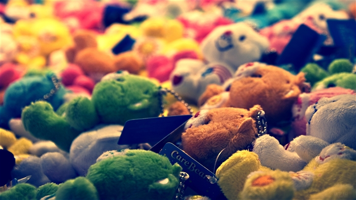 Care Bears plush toys in a pile